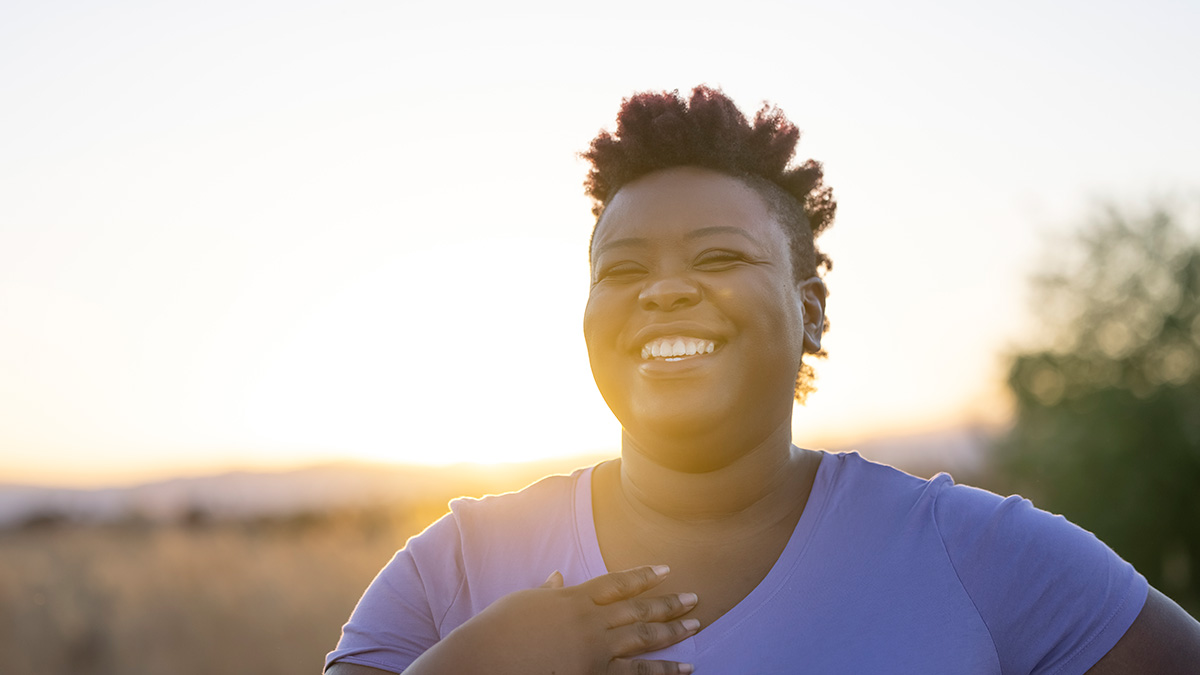 woman smiling with sunset